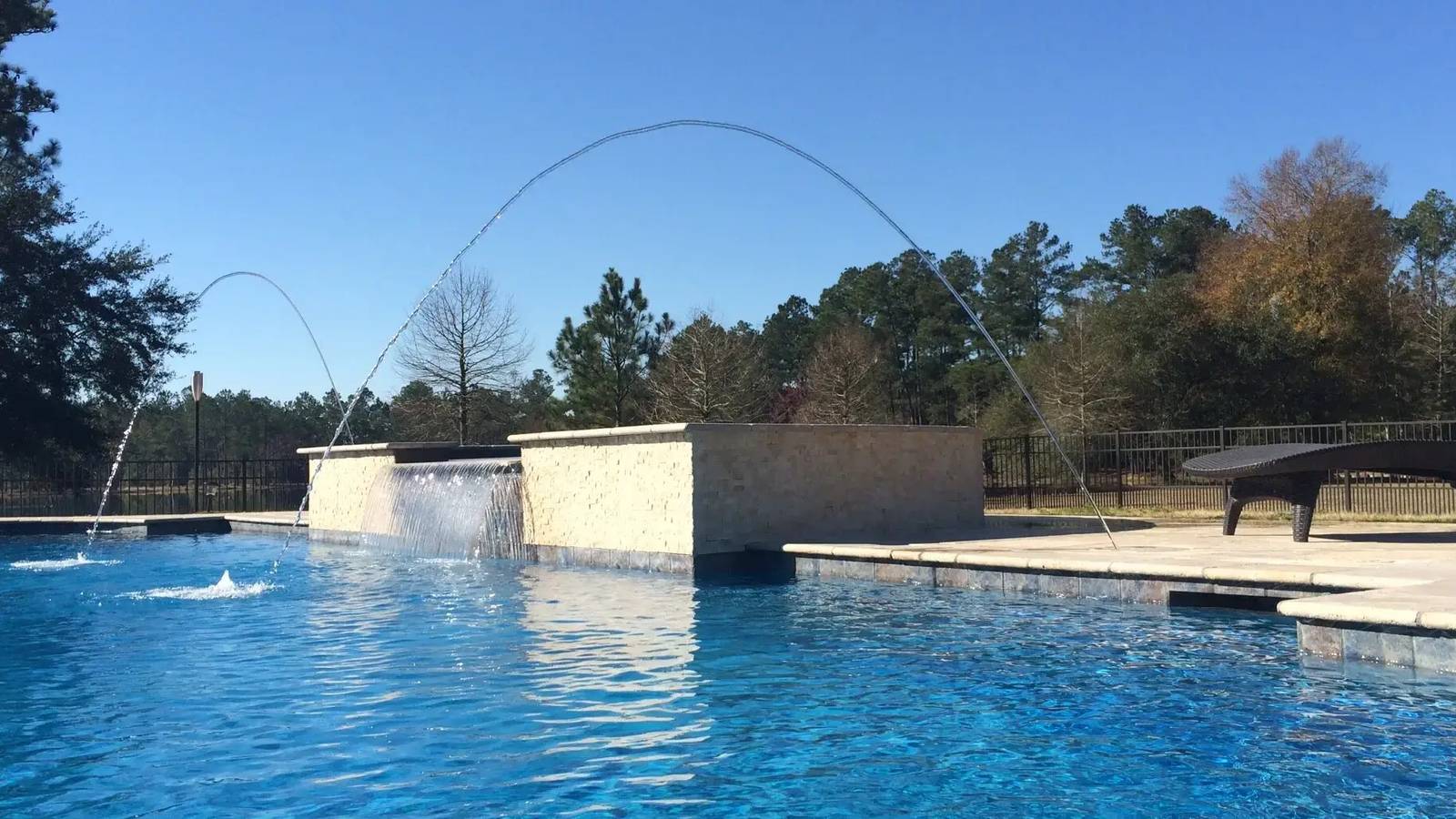 Custom swimming pool in Covington, LA with a stone waterfall wall and deck jets