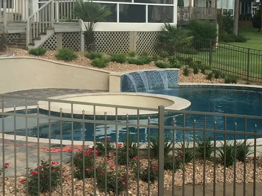 Raised spa and sheer-descent wall on a custom pool